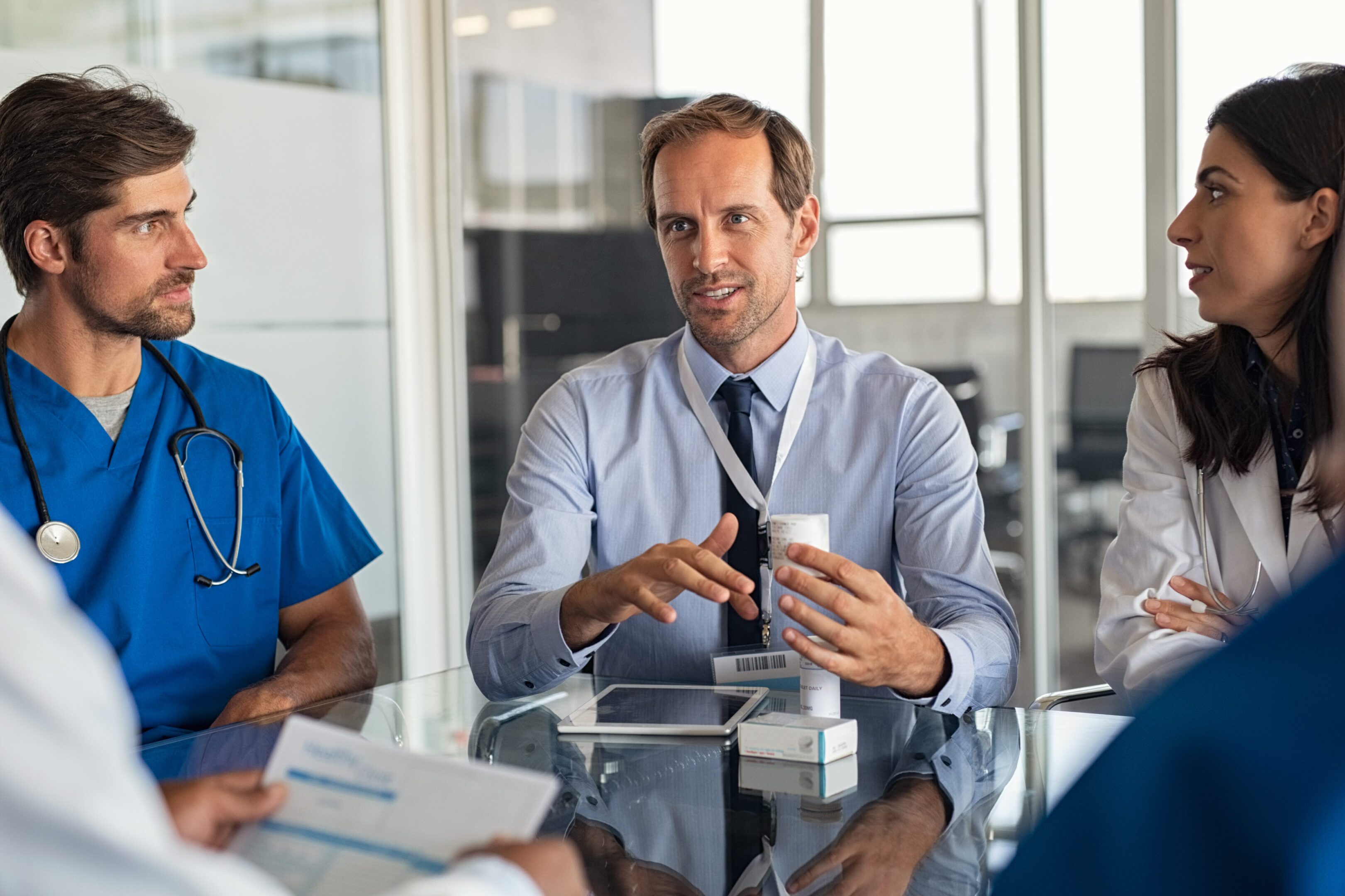 A man sitting at a table with other people.