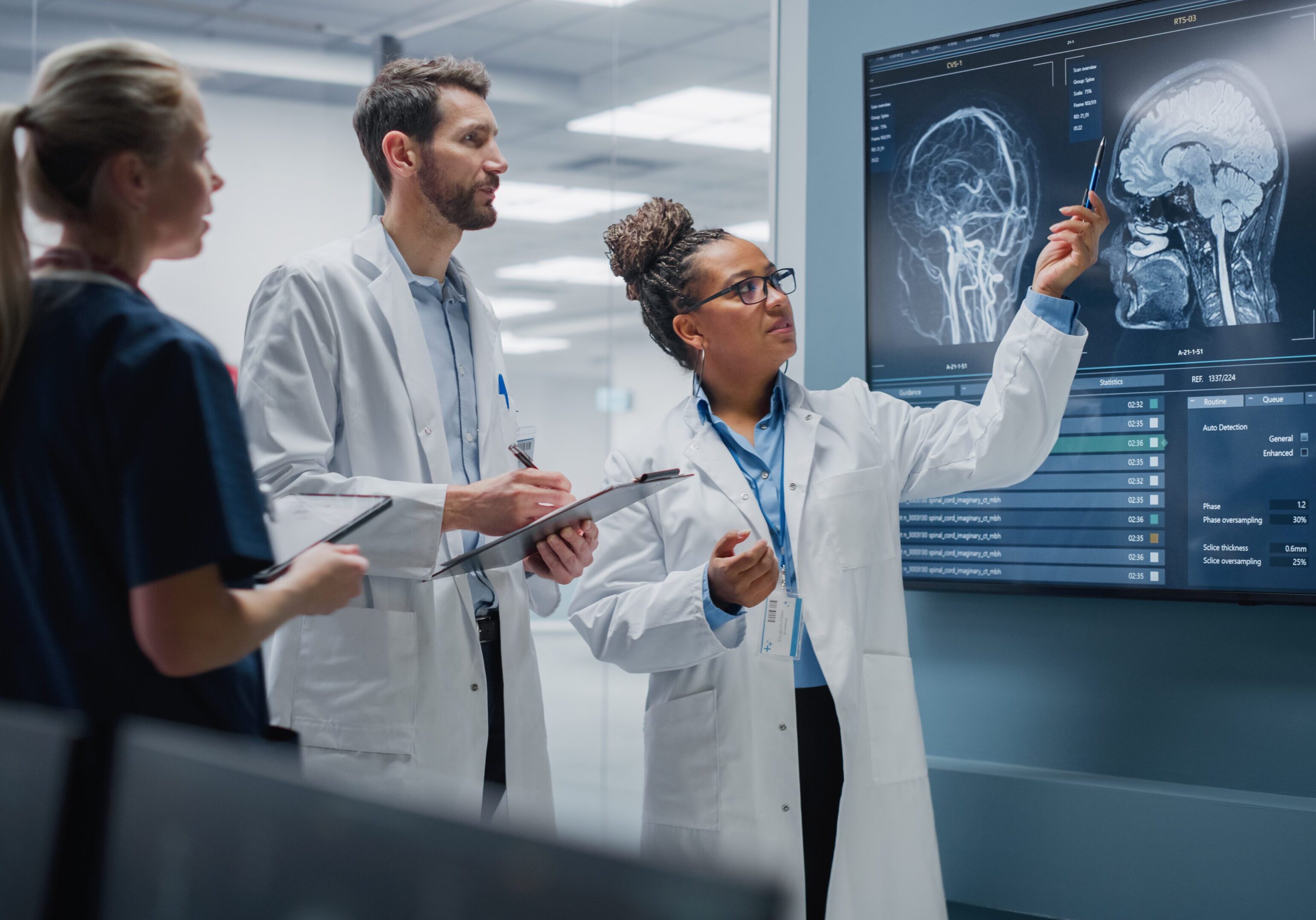 A group of doctors are looking at an image on the wall.